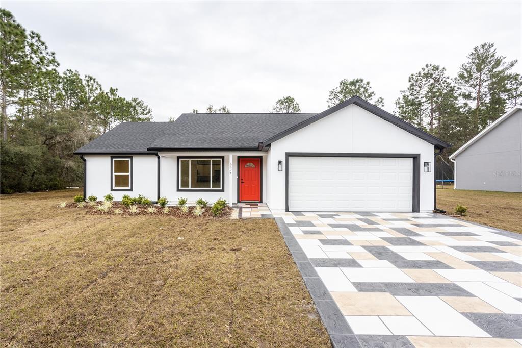 a view of a house with a yard and garage