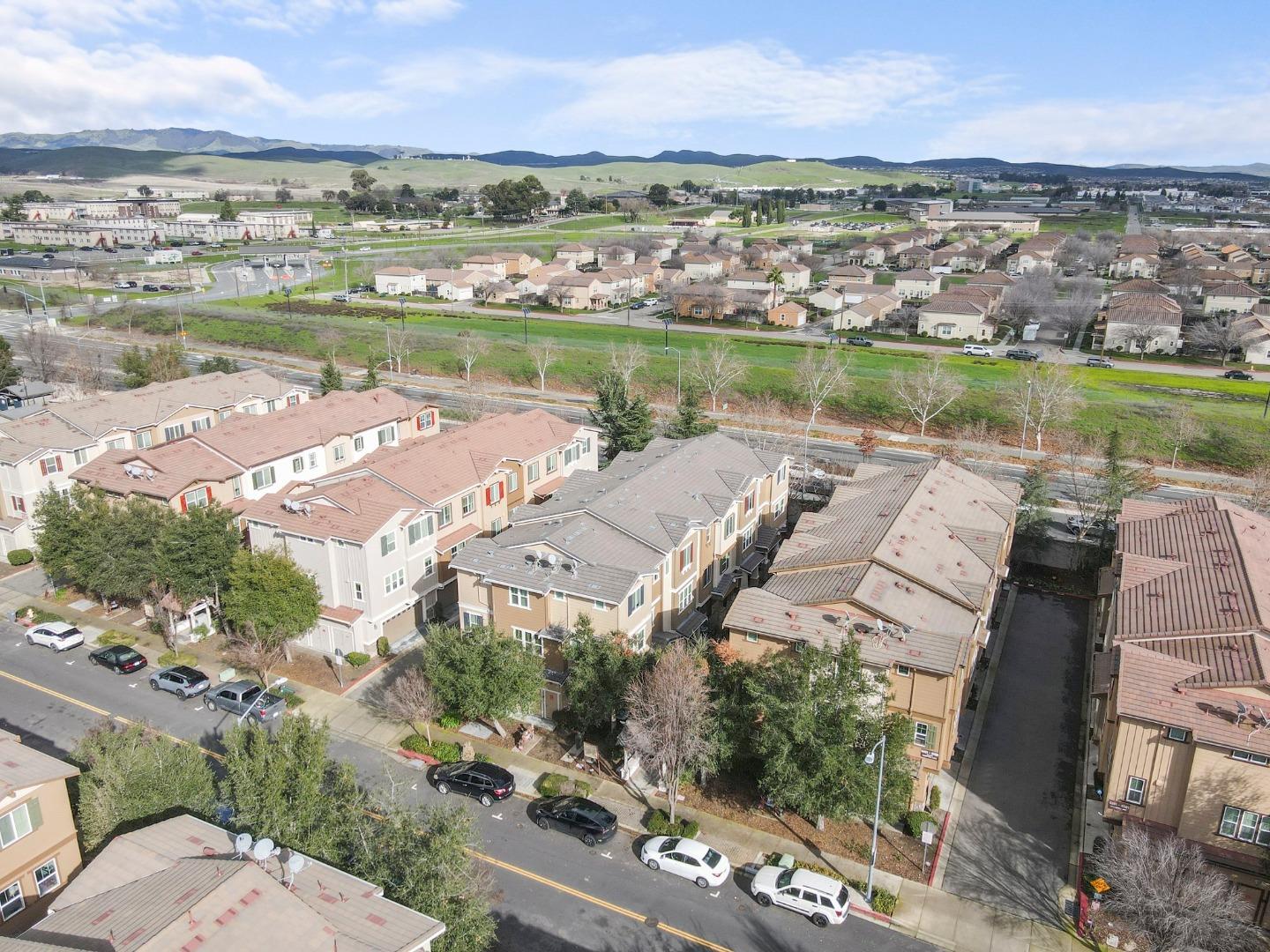 an aerial view of residential houses with outdoor space and river