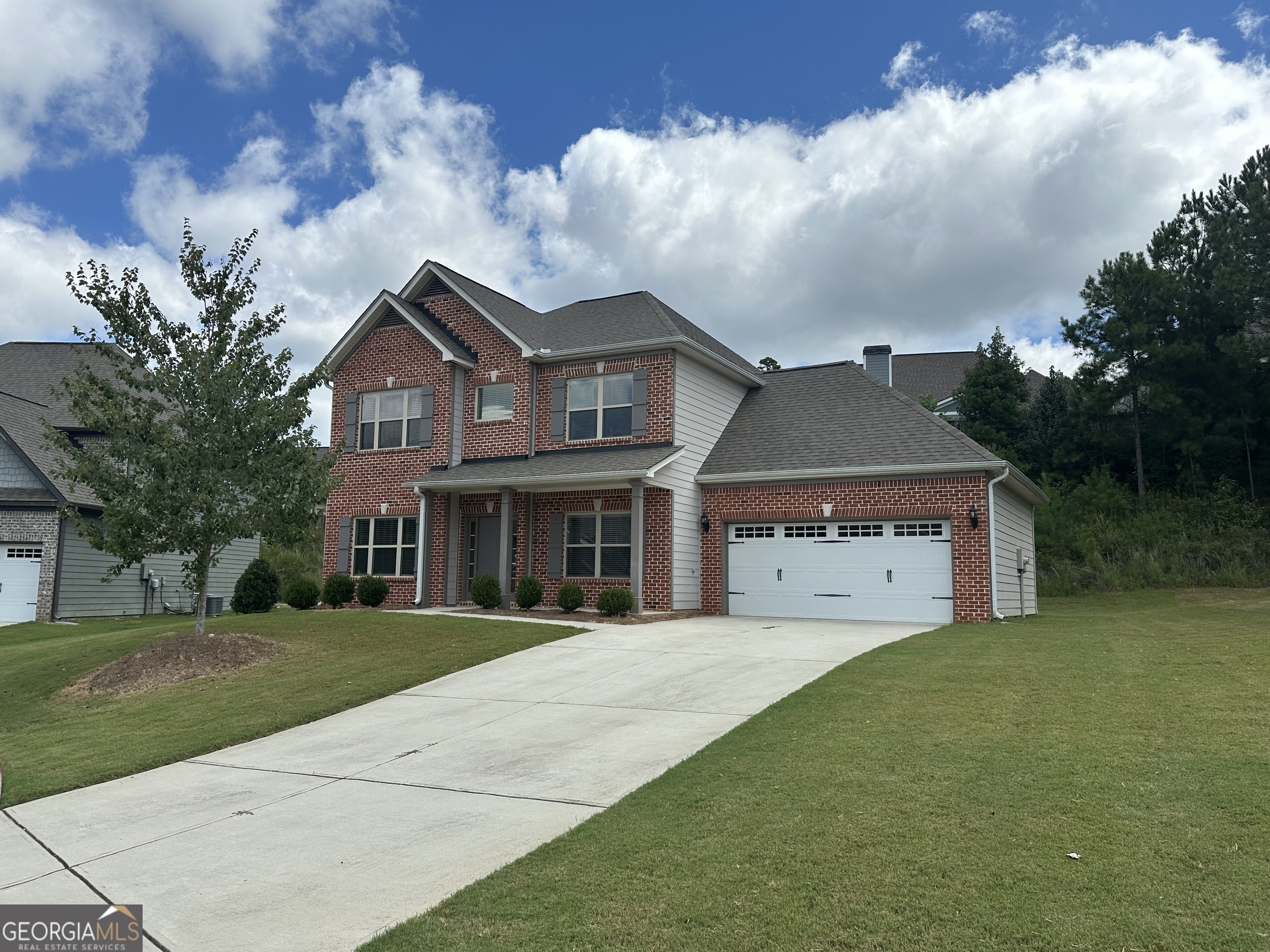 a front view of a house with a garden