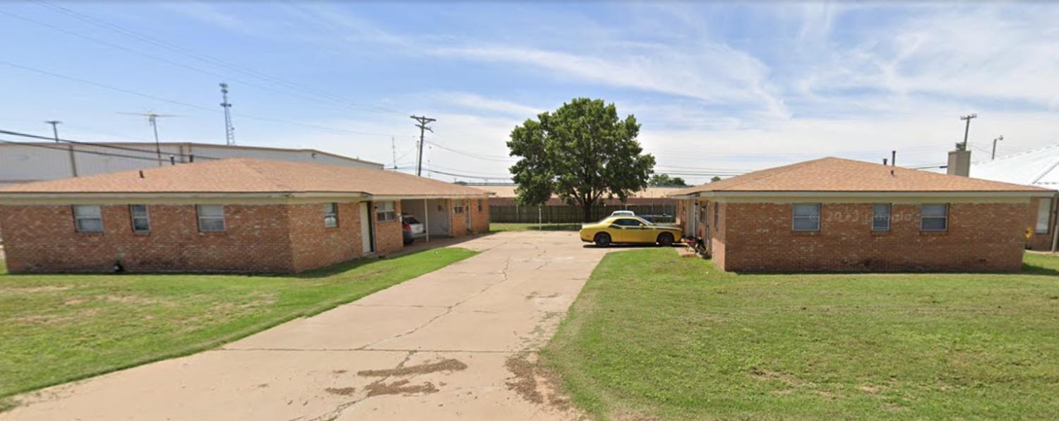 a front view of house with yard and car parked