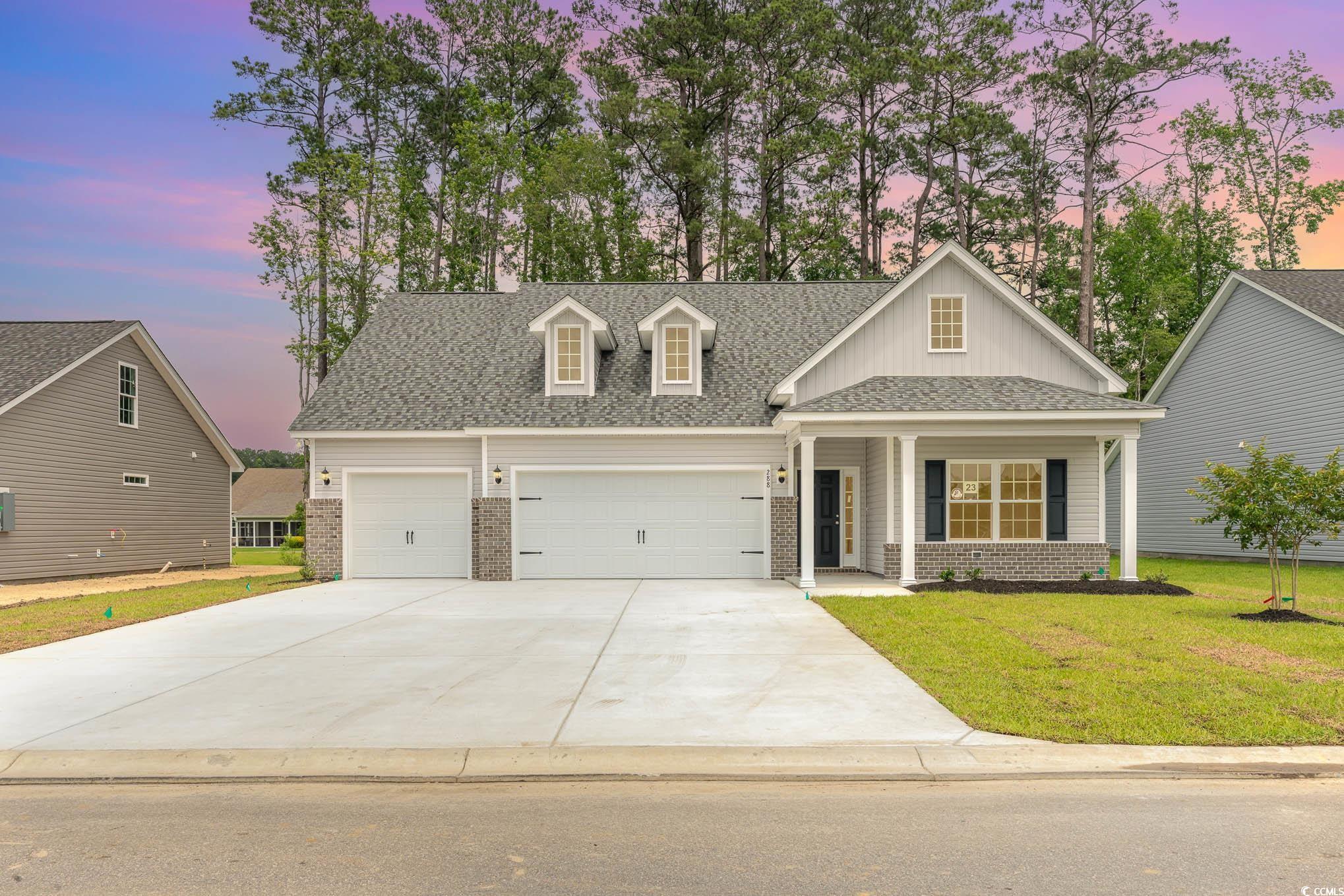 View of front of property with a lawn and a garage