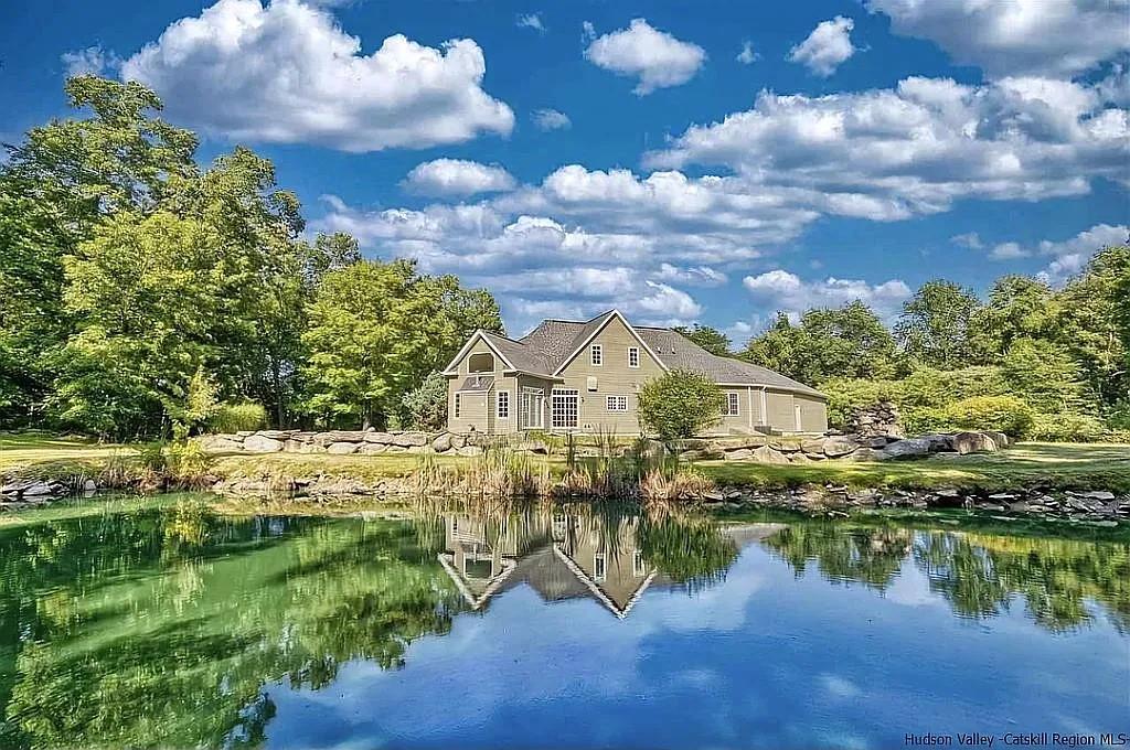 a view of a lake with a house in the background