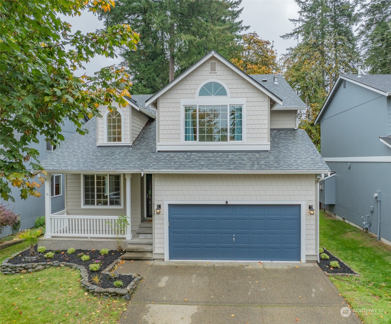 a front view of a house with a yard and garage