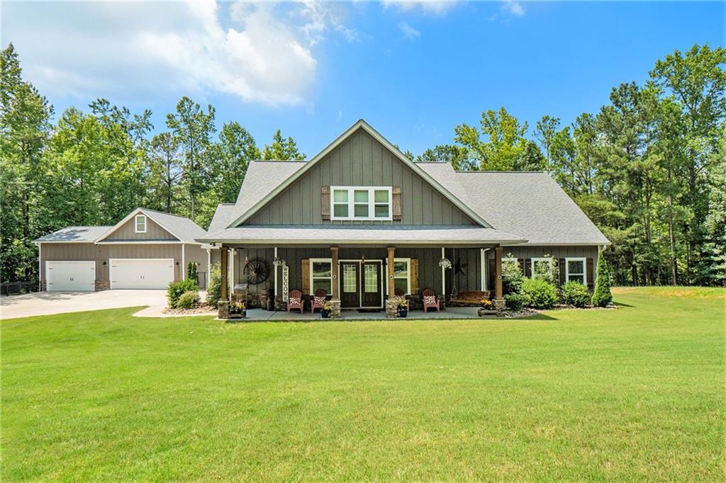 a front view of a house with a yard and trees