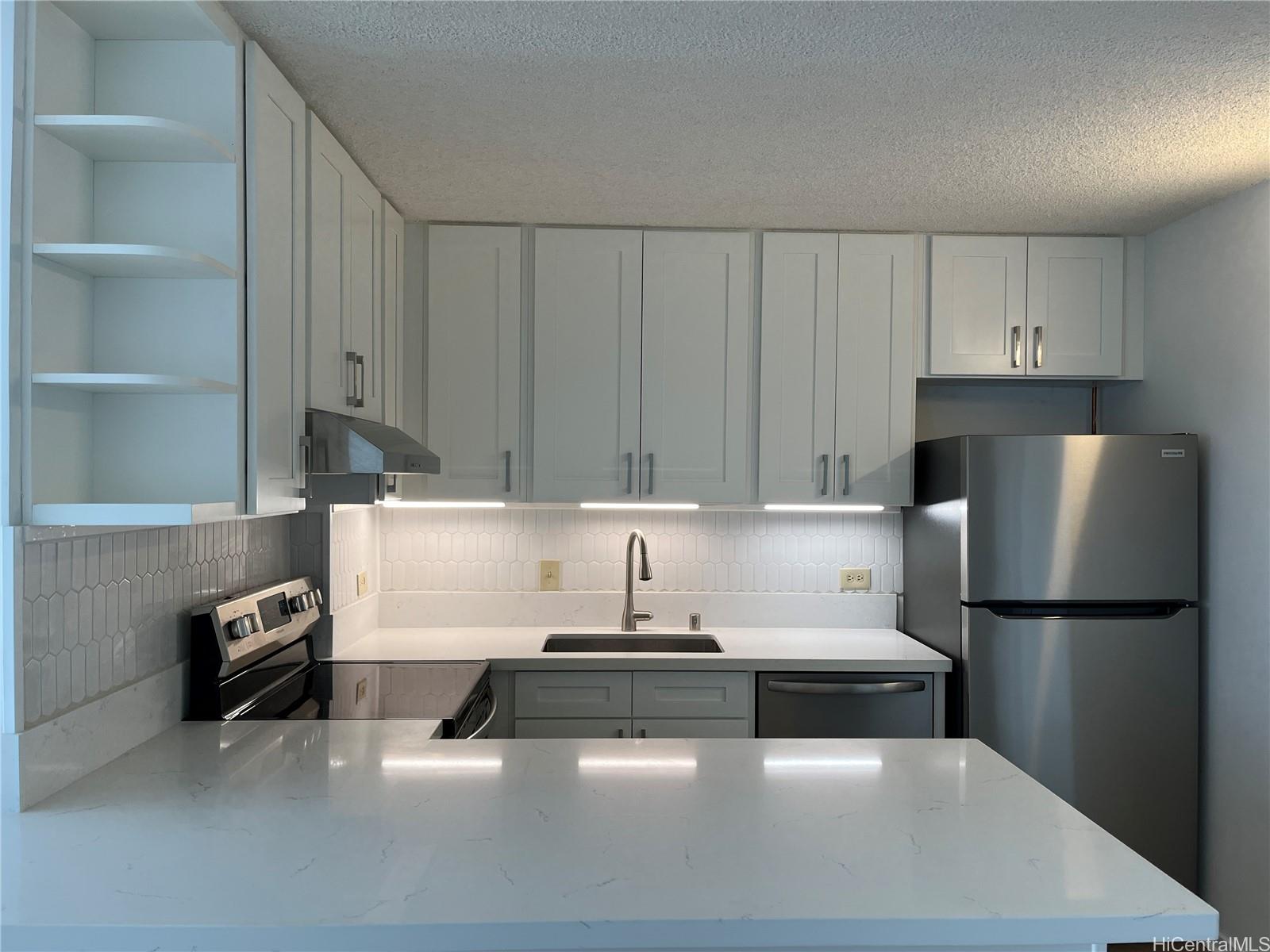 a kitchen with a refrigerator and a sink