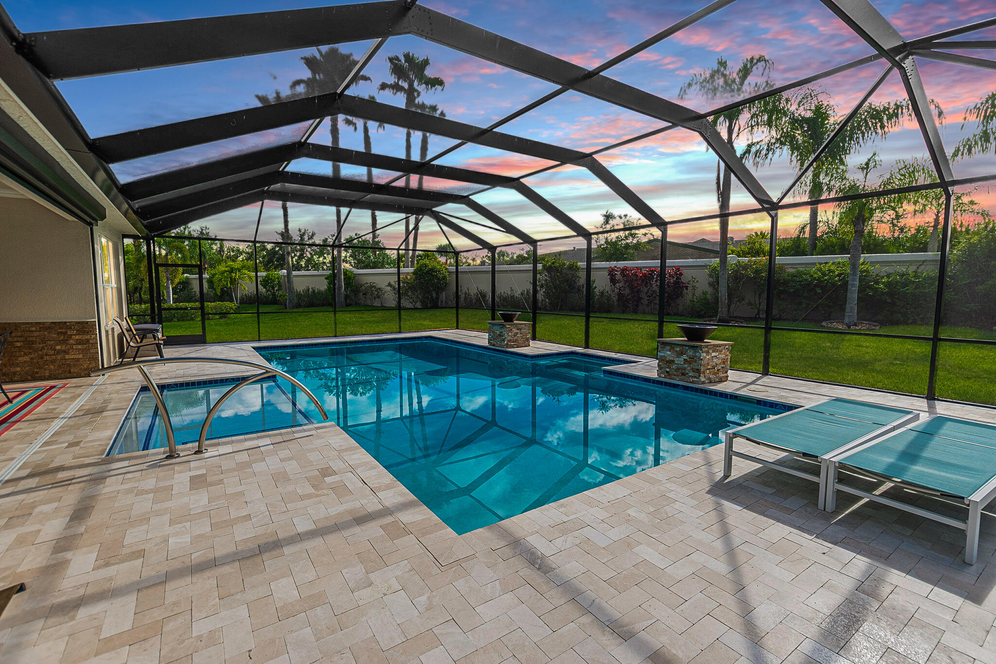 a view of a swimming pool with a patio and a yard