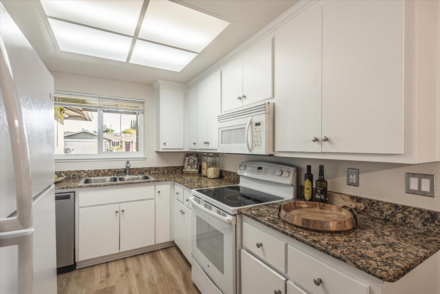 a kitchen with a sink stove and cabinets