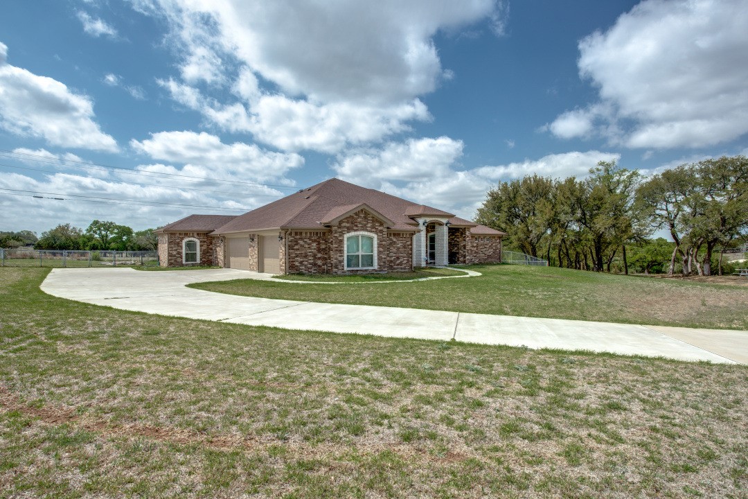 a house view with swimming pool and green space