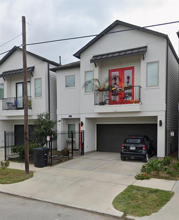 a front view of a house with cars