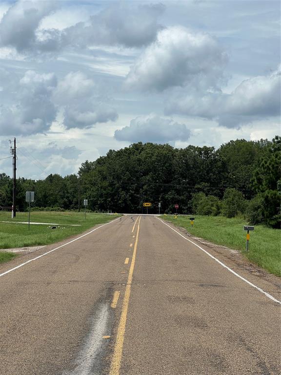 a view of a road with a big yard