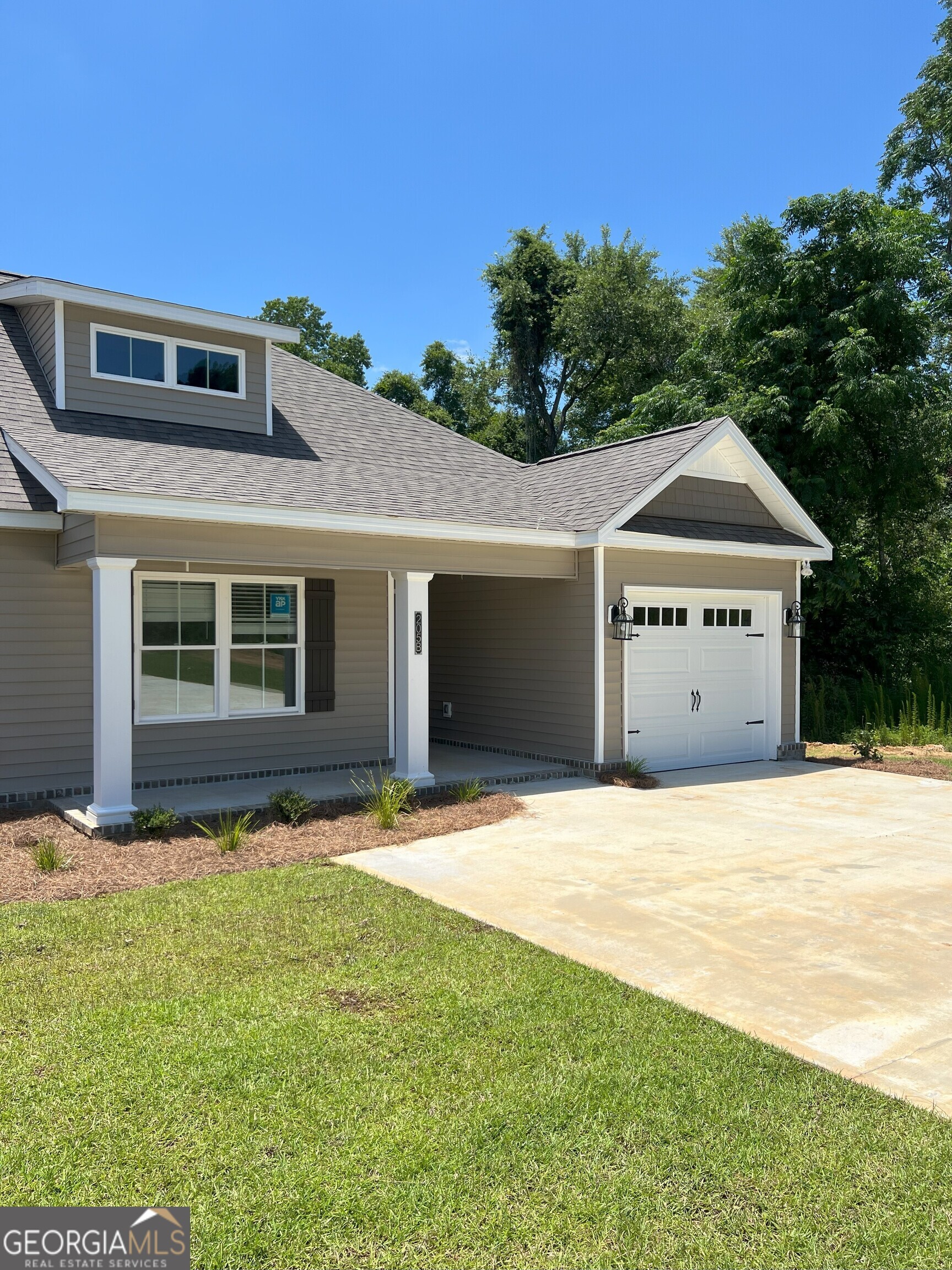 a front view of a house with a yard