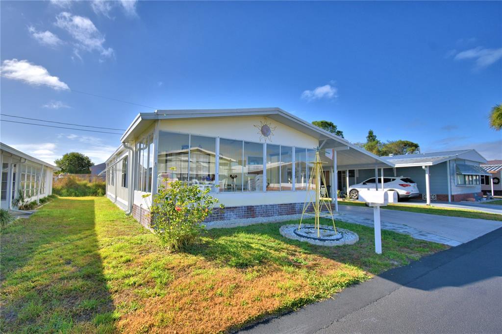 a view of a house with a yard porch and sitting area