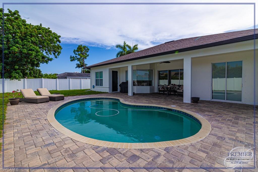 a view of a house with swimming pool and porch