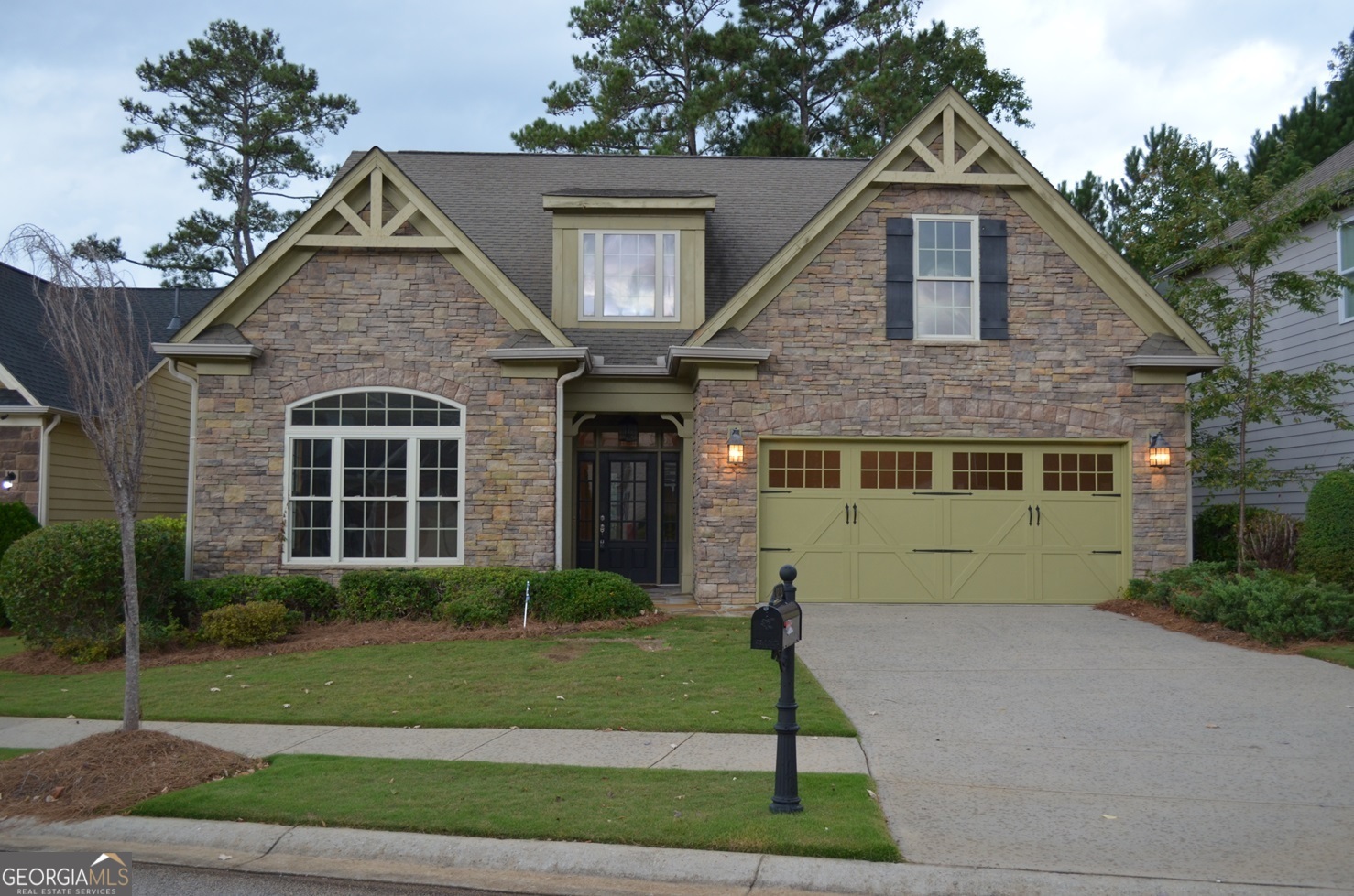 a front view of a house with a garden