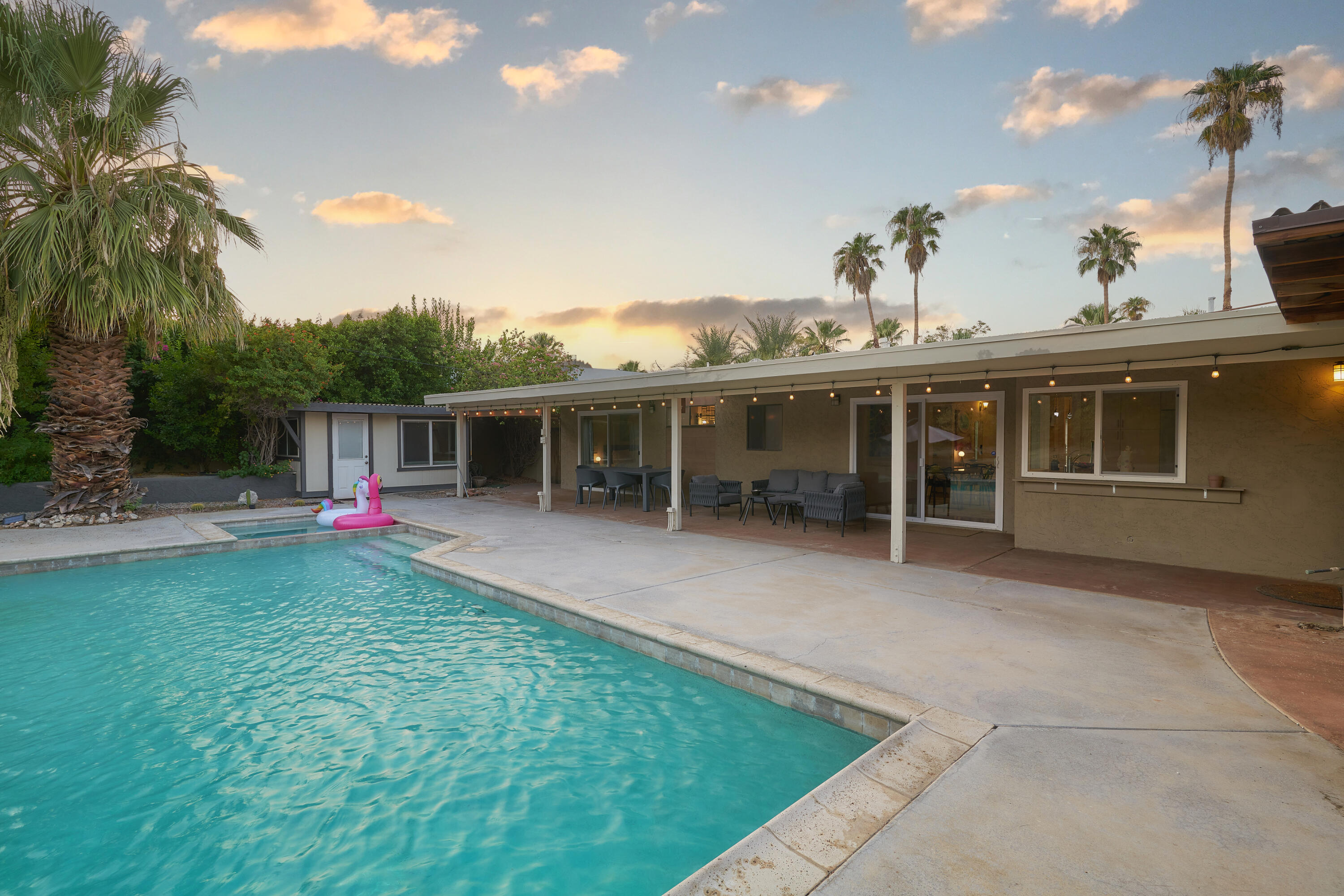 a view of a house with a backyard and a patio