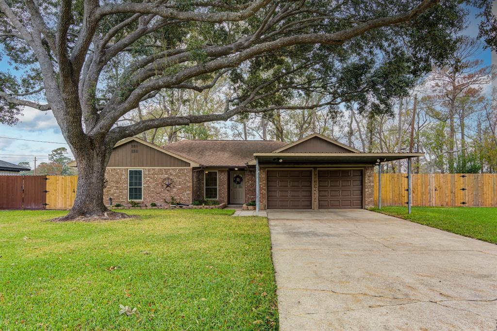 a front view of house with yard and trees