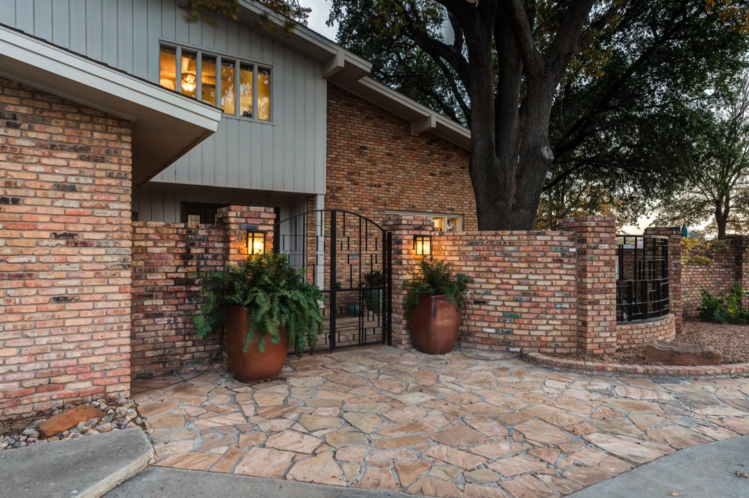 a view of a patio with plants and a barbeque