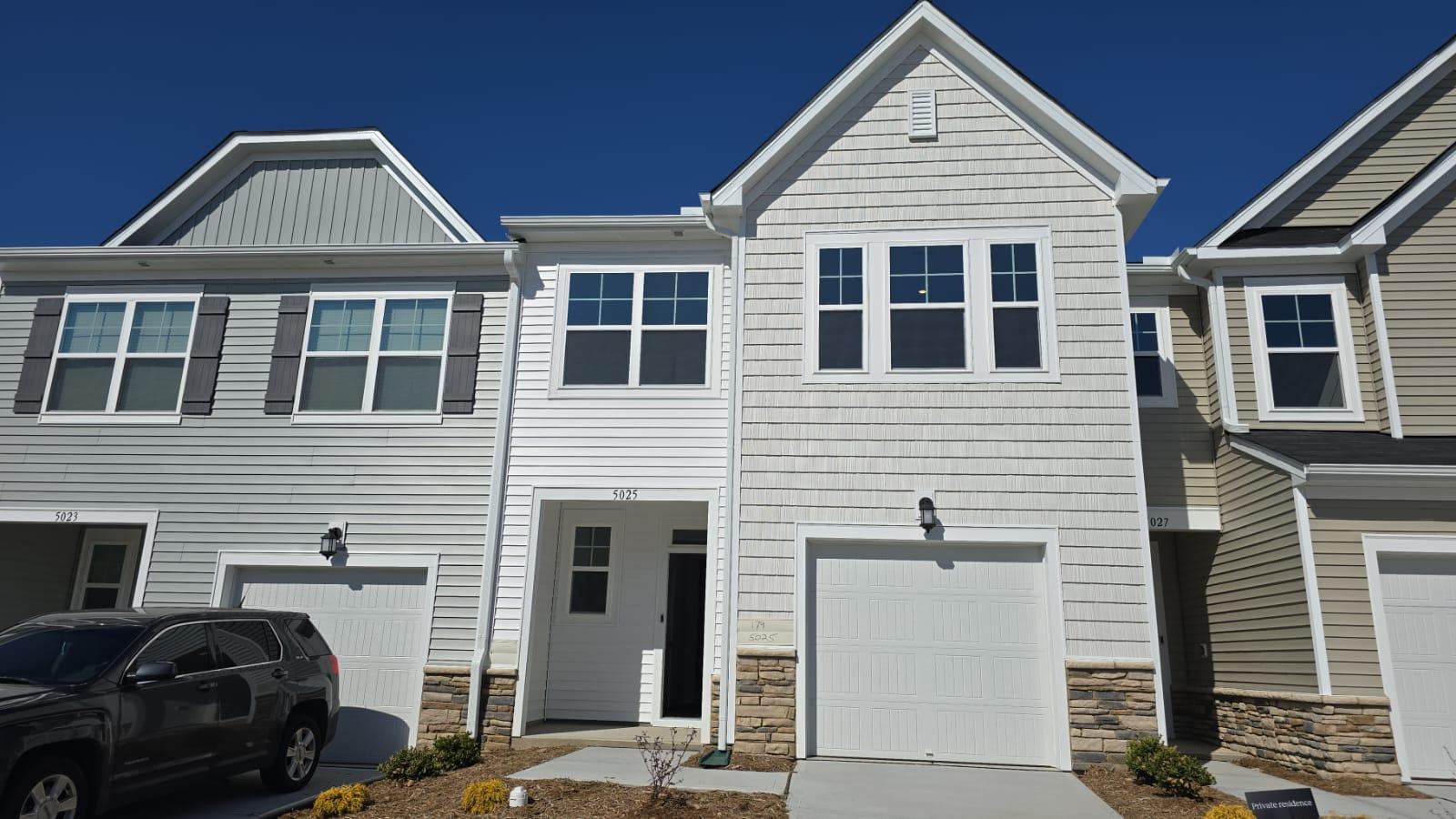 a front view of a house with parking space