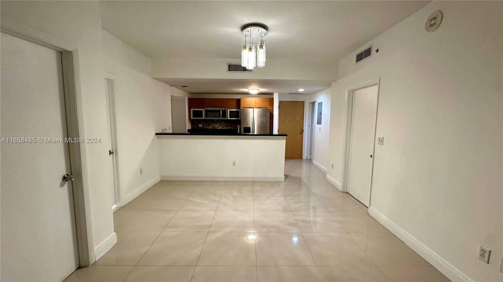 a view of a hallway to rooms and stairs