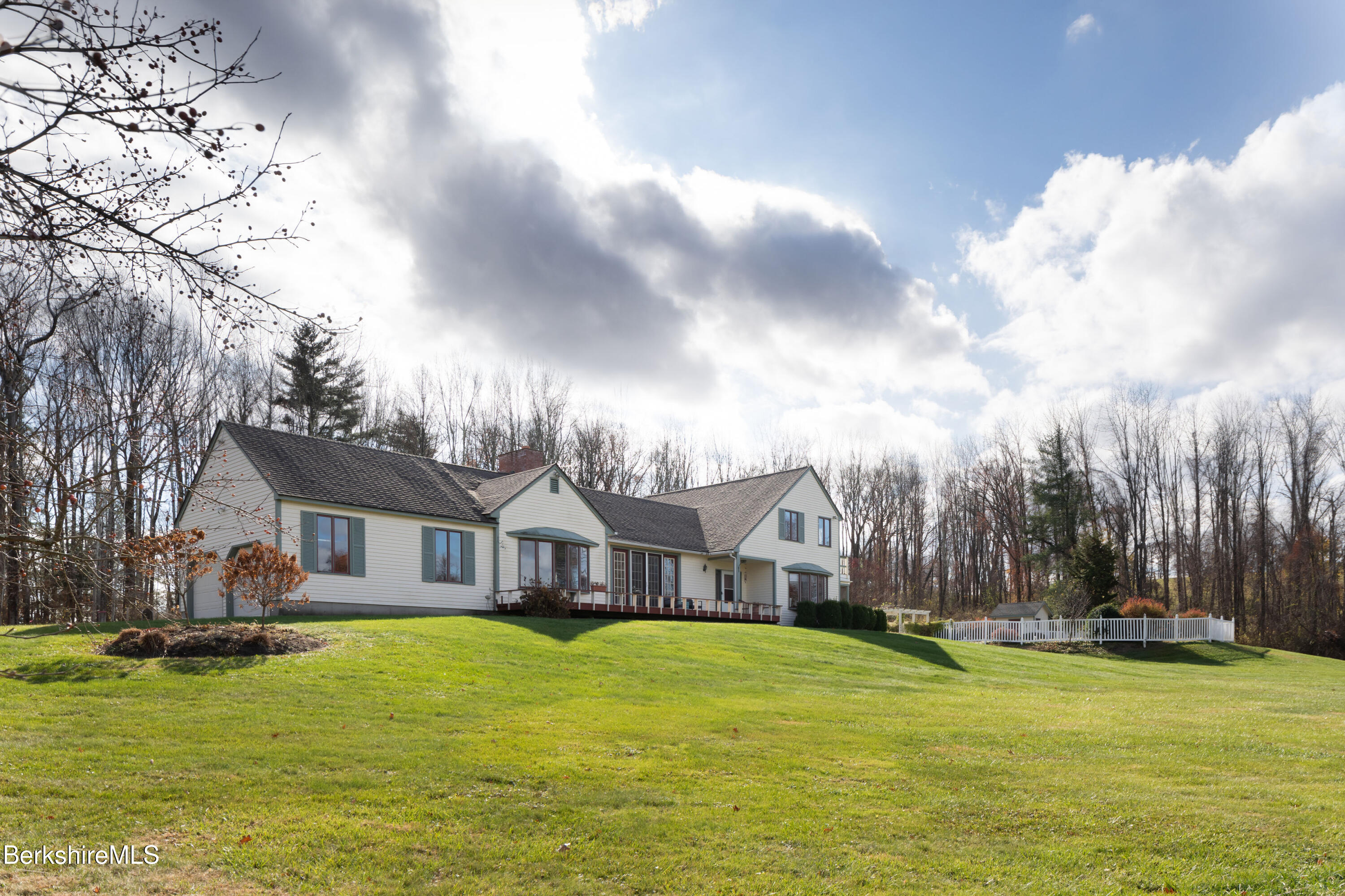 a front view of house with yard and swimming pool