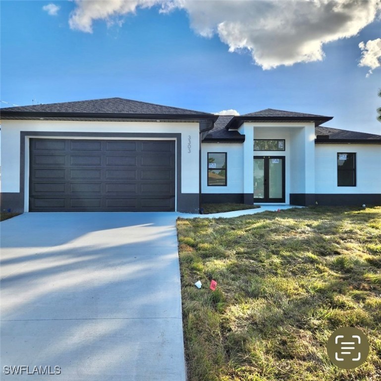 a view of house with backyard and garage