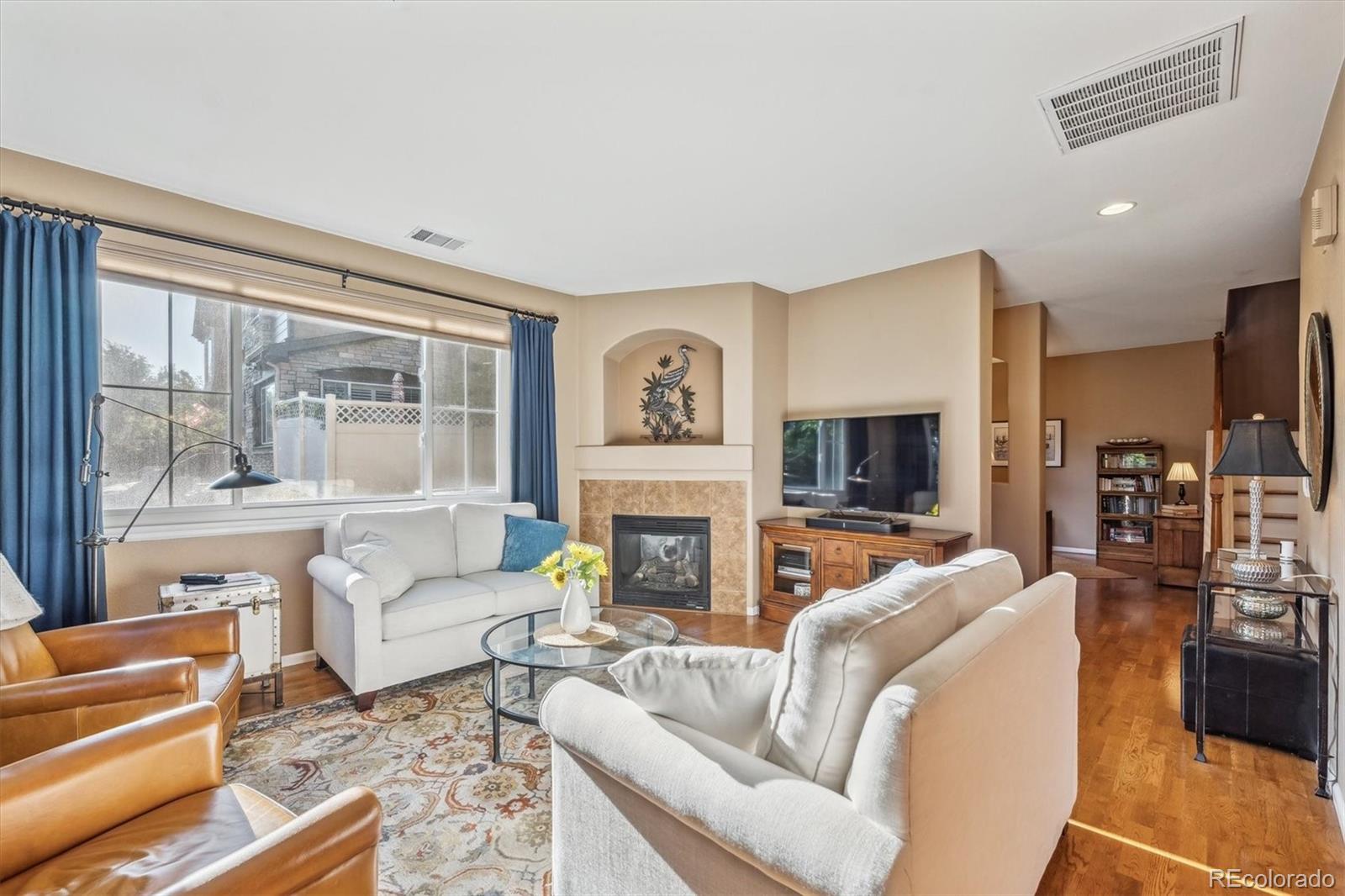 a living room with fireplace furniture and a flat screen tv