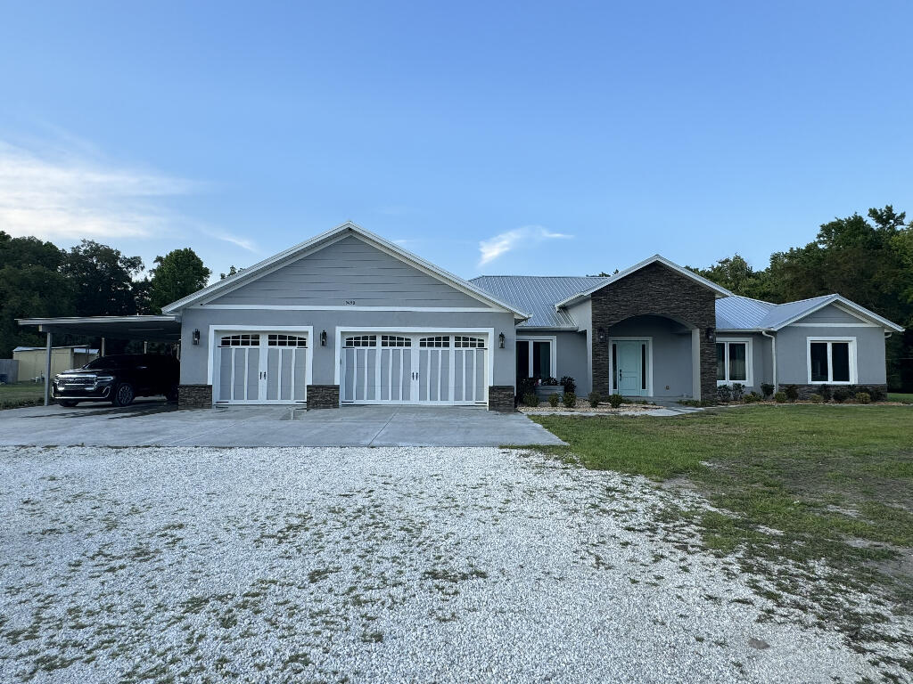 a front view of a house with a garden