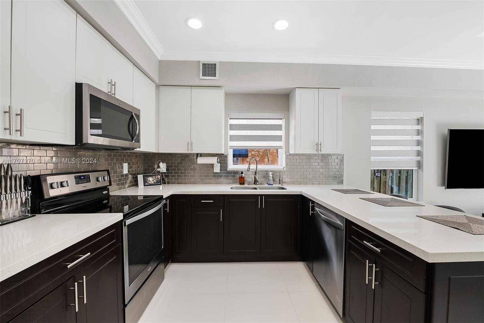 a kitchen with a sink stove top oven and cabinets