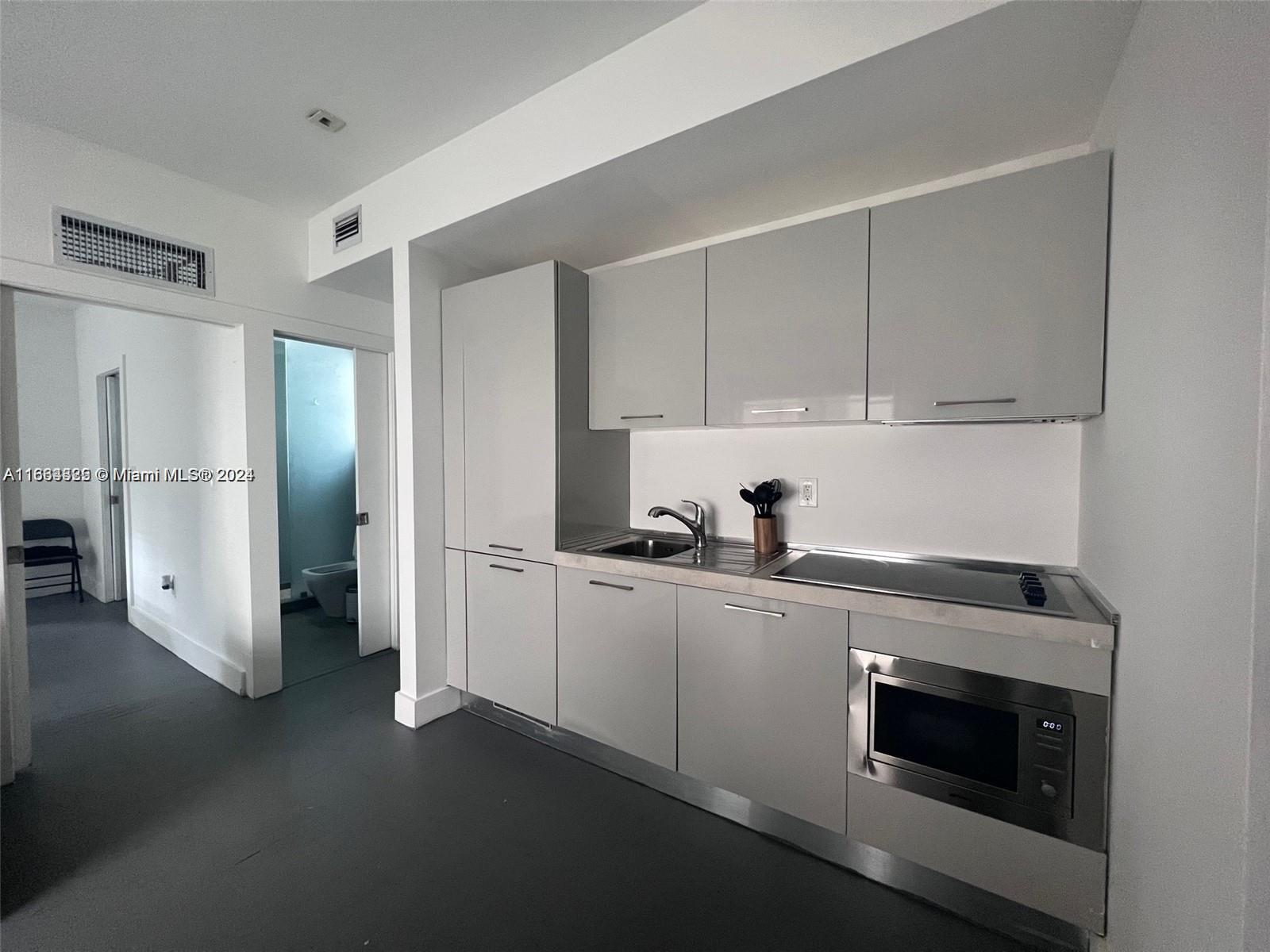 a kitchen with stainless steel appliances a stove and a refrigerator