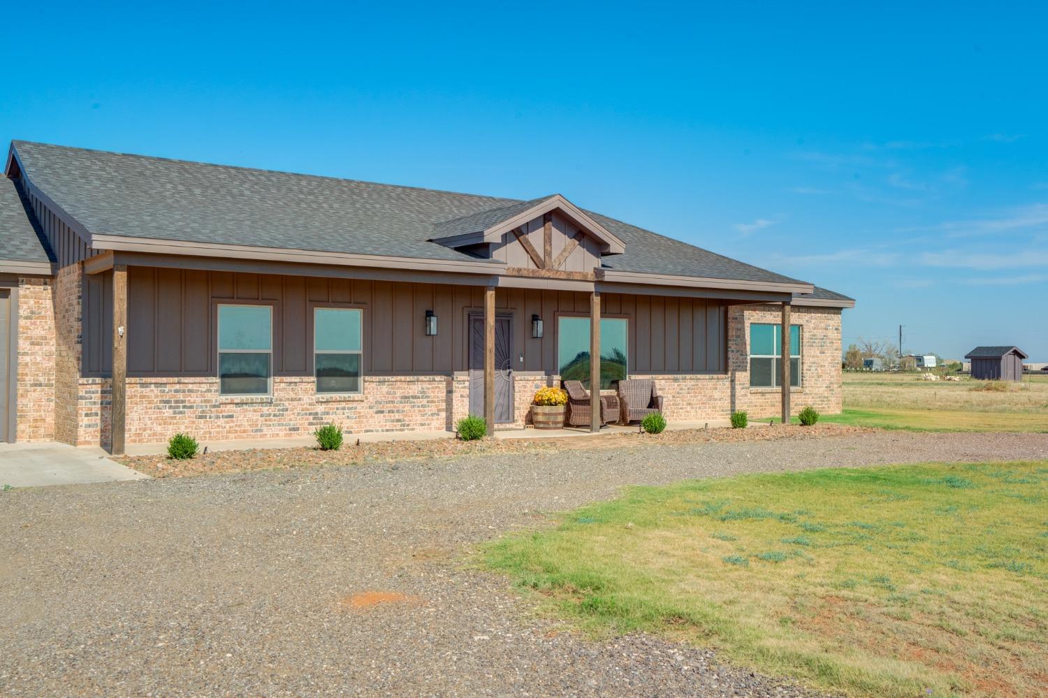 a front view of a house with swimming pool and porch