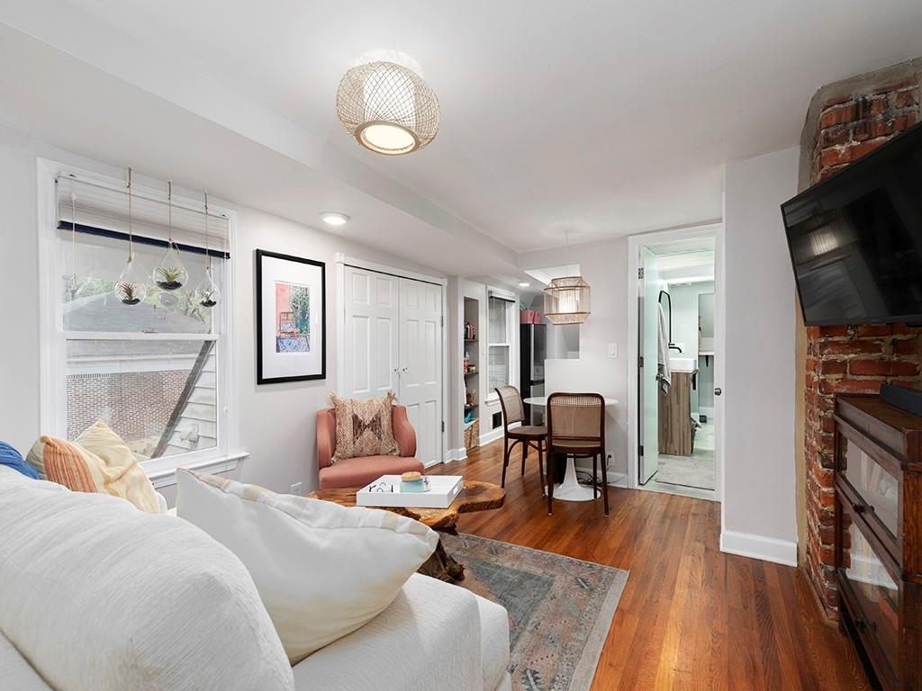 a bedroom with furniture and a wooden floor