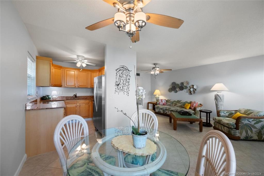 a dining room with furniture a chandelier and wooden floor