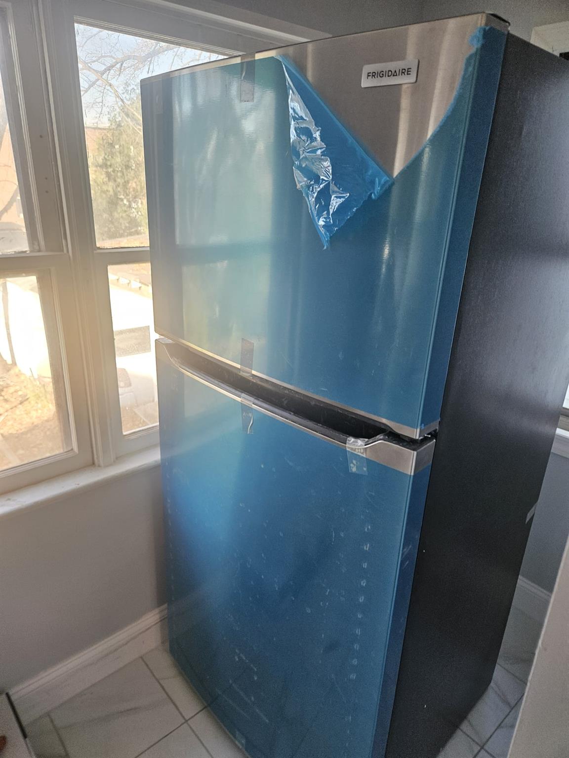 Interior details with stainless steel fridge and blue cabinets