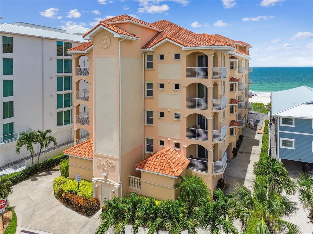 a front view of a multi story residential apartment building with a yard