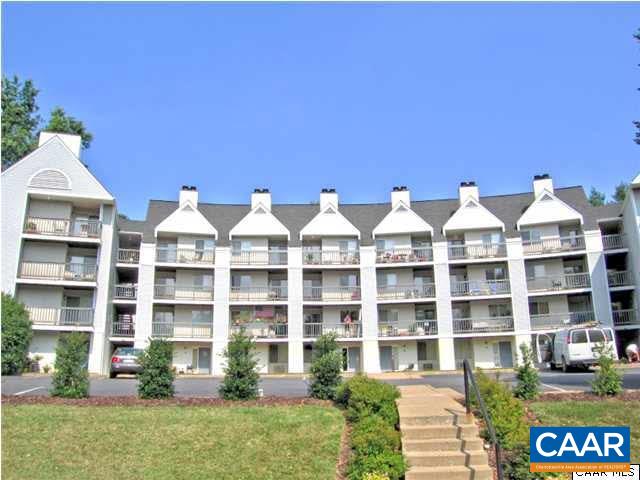 a front view of a residential apartment building with a yard