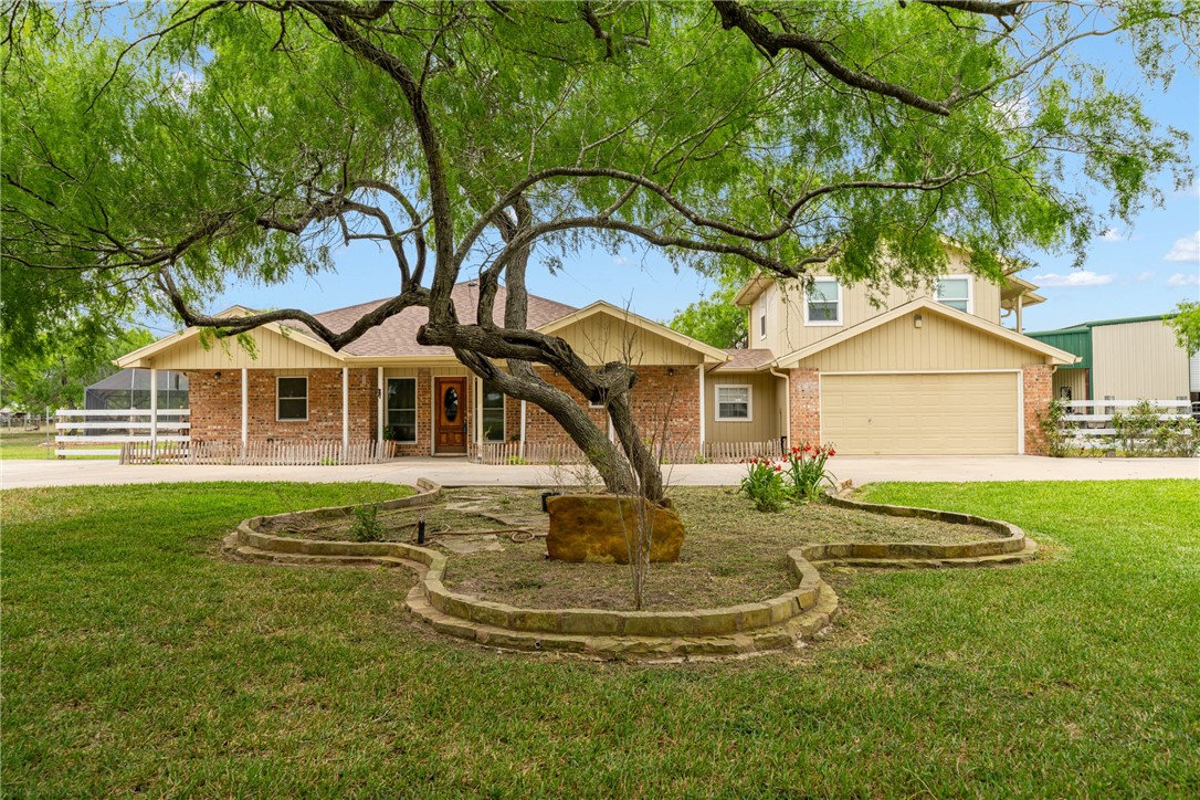 a front view of house with yard and green space