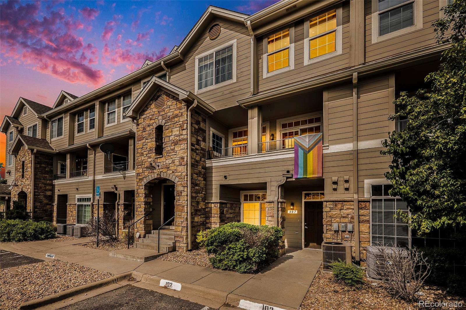 a front view of a residential apartment building with a yard