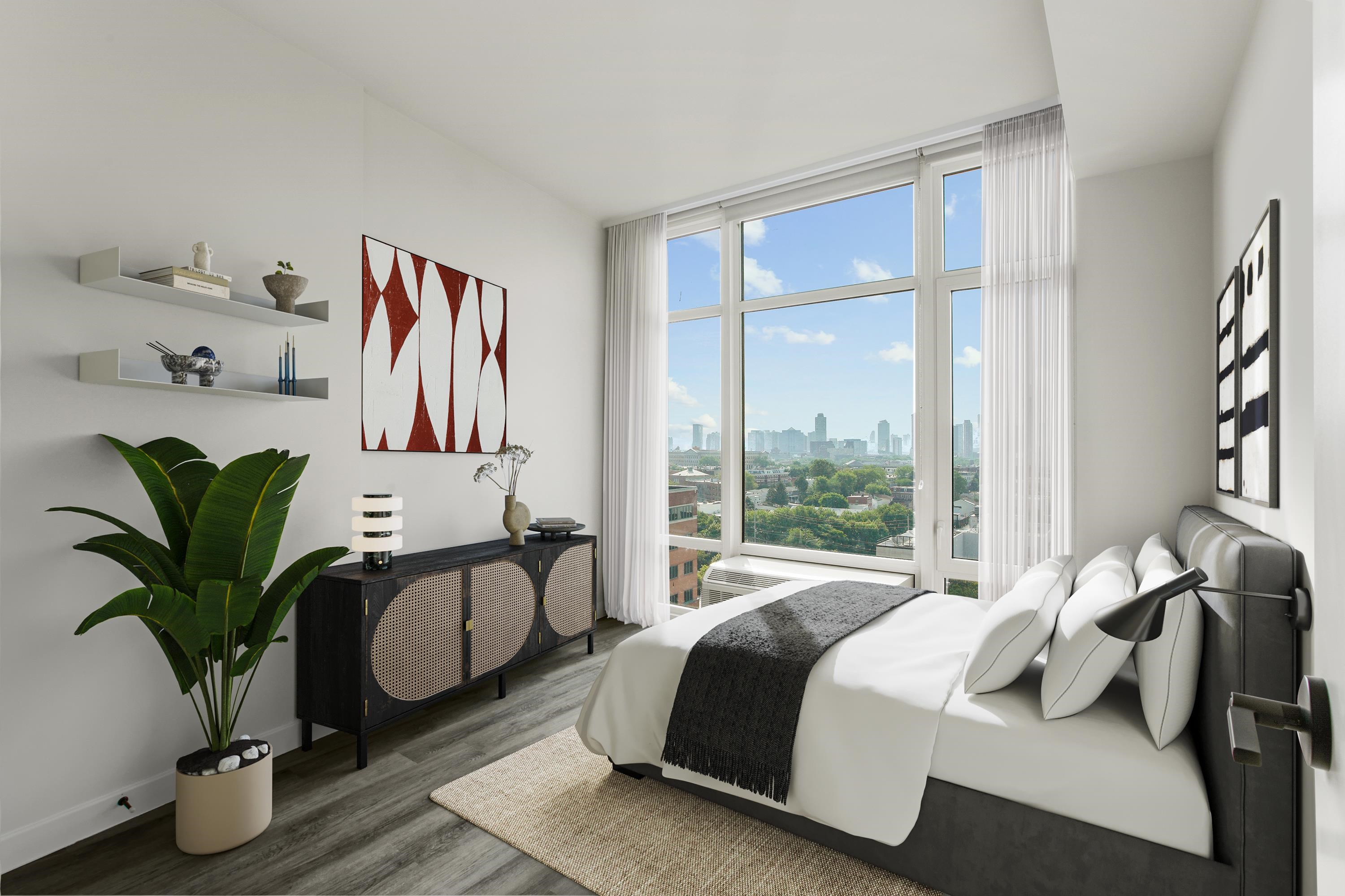 a bedroom with a bed and a potted plant