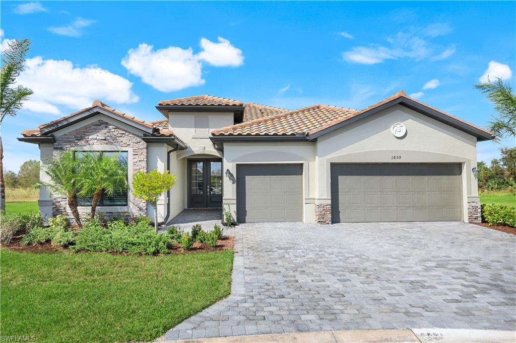 a front view of a house with a yard and garage