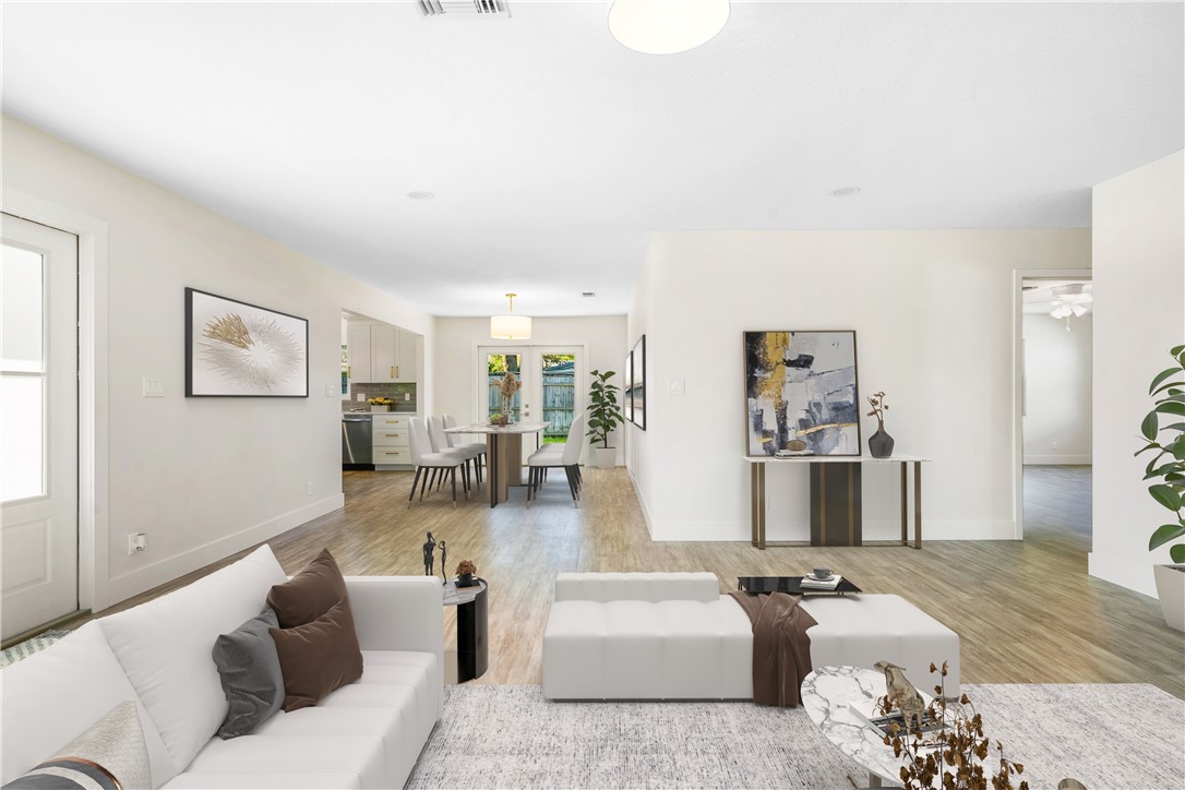 a living room with furniture and wooden floor