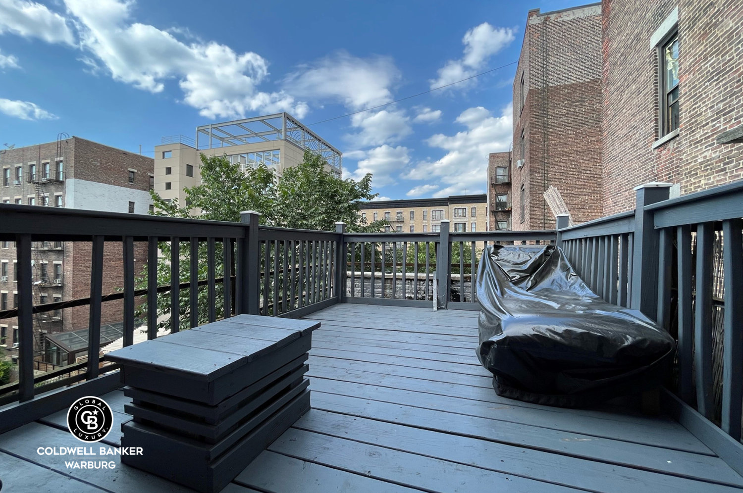 a view of a balcony with wooden floor and outdoor space