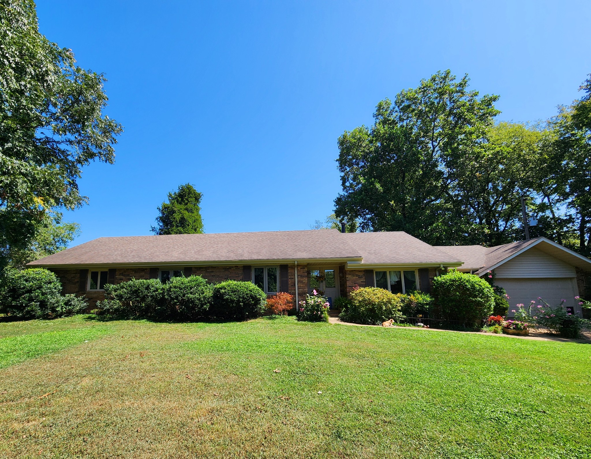 a view of a house with a yard and sitting area