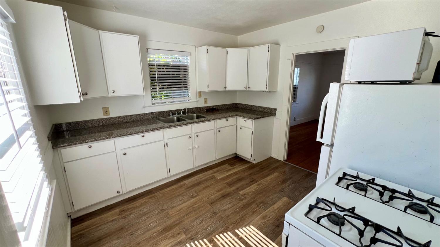 a kitchen with a sink stove and cabinets