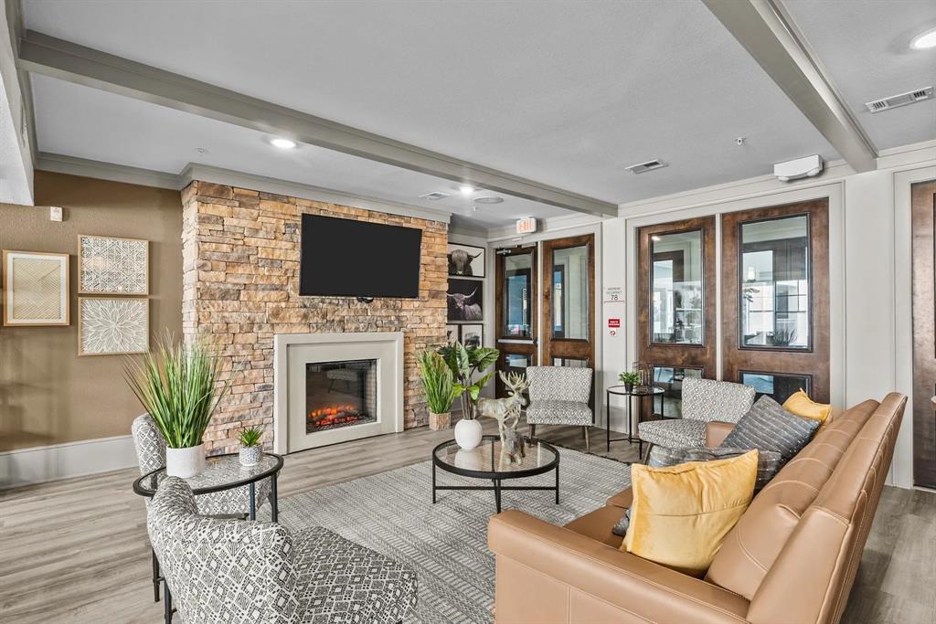 a living room with furniture a fireplace and a flat screen tv