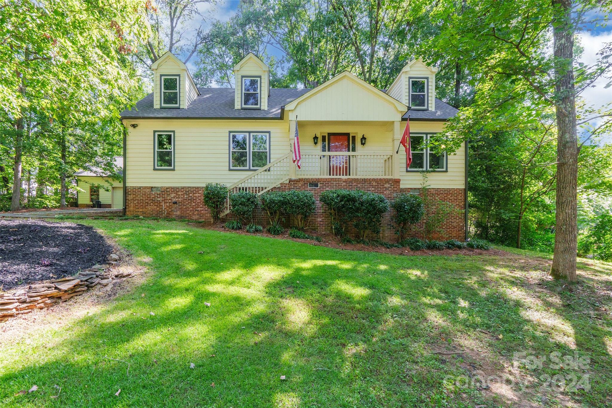 a front view of a house with garden