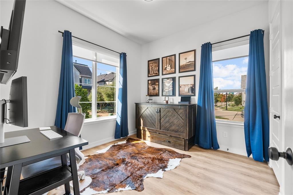 a bedroom with a bed and a table next to a window