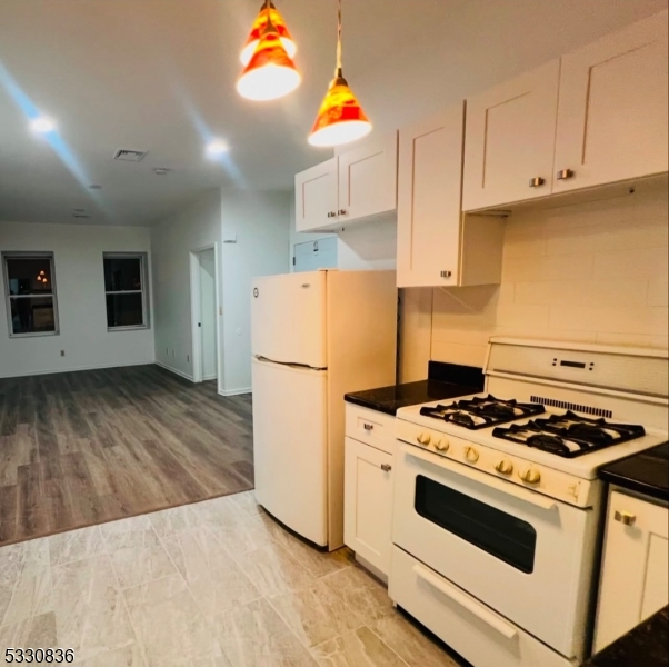 a kitchen with a stove a refrigerator and a stove