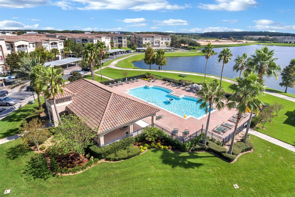 an aerial view of a house with a garden and lake view