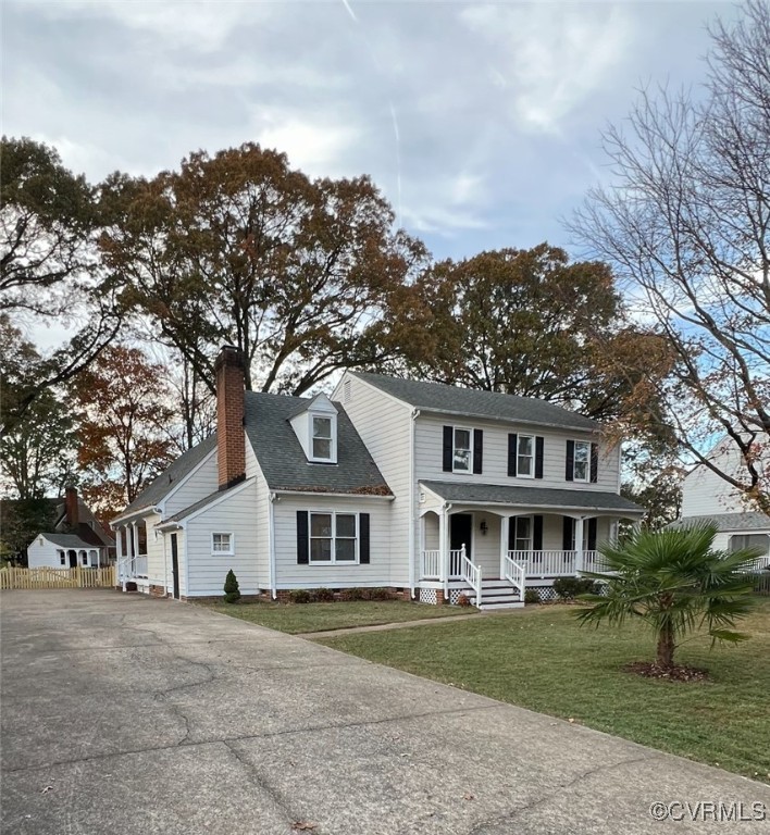 View of front of house with covered porch and a fr