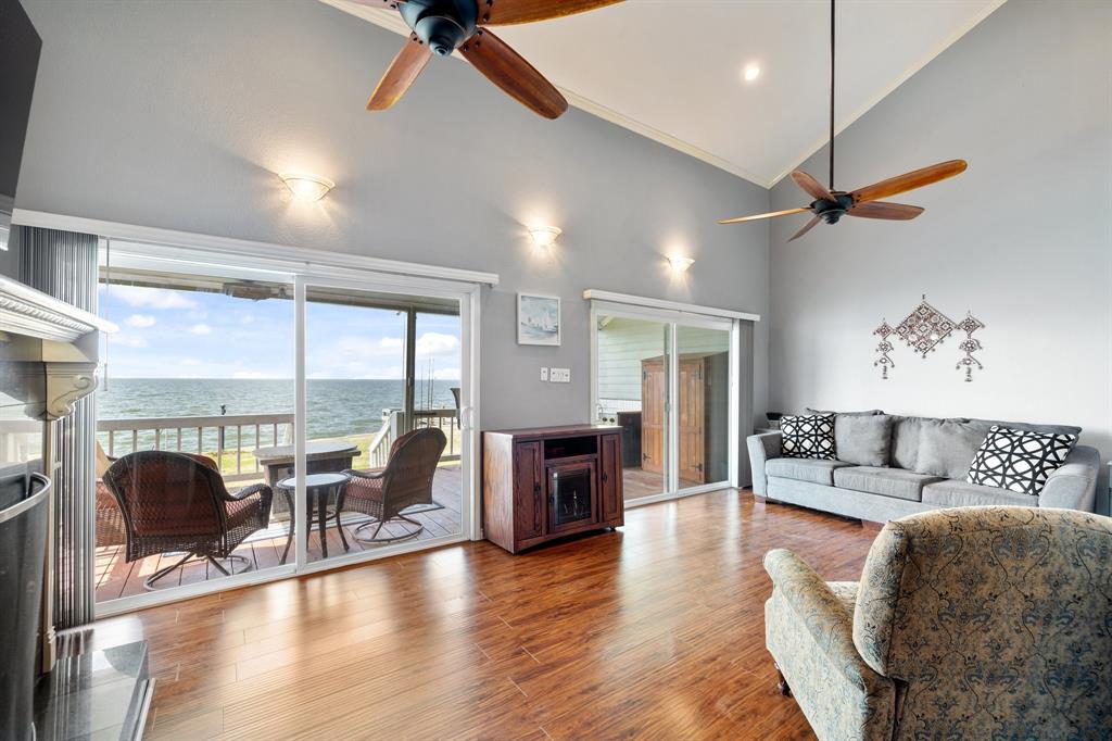 a living room with furniture a fireplace and wooden floor